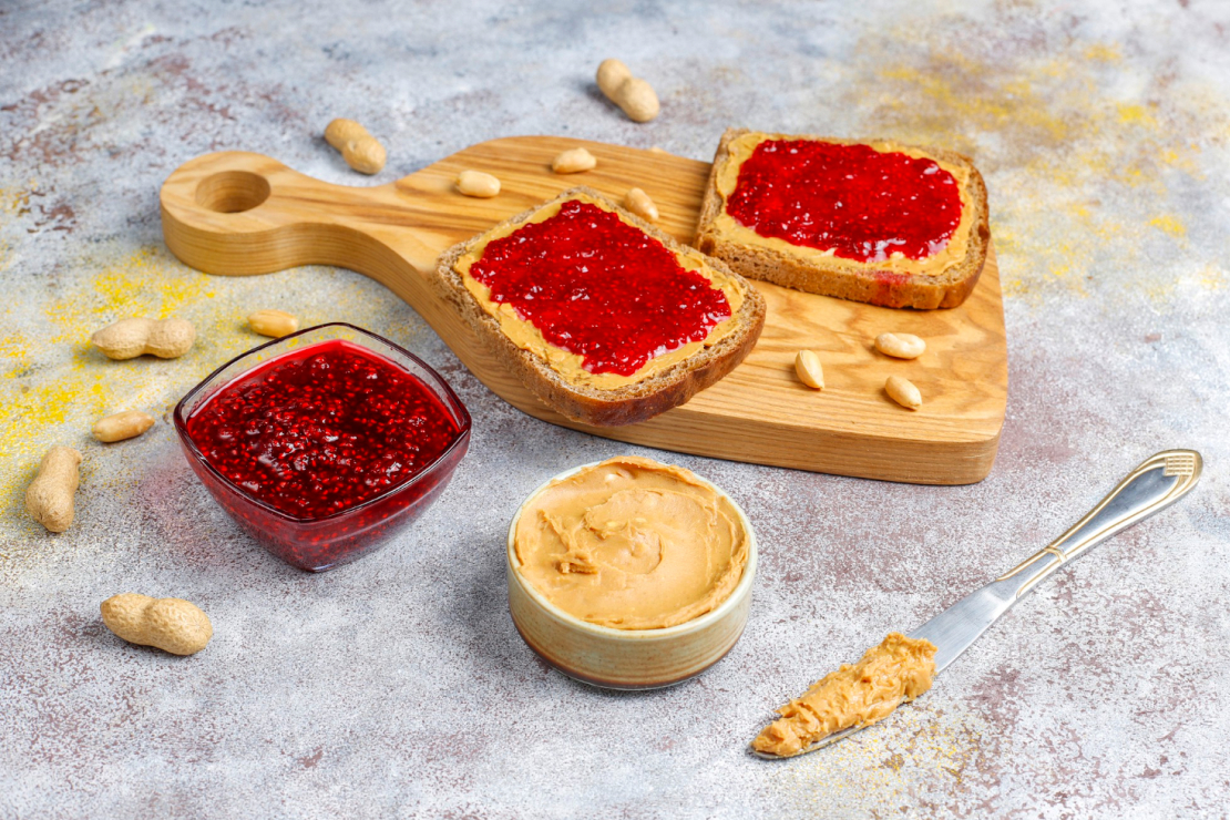 A classic peanut butter and jelly sandwich cut diagonally on a plate